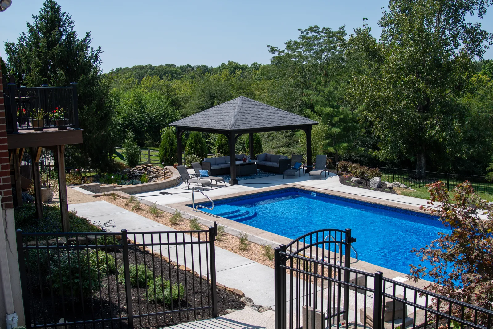 Finished backyard with retaining wall, pool landscape and new plantings
