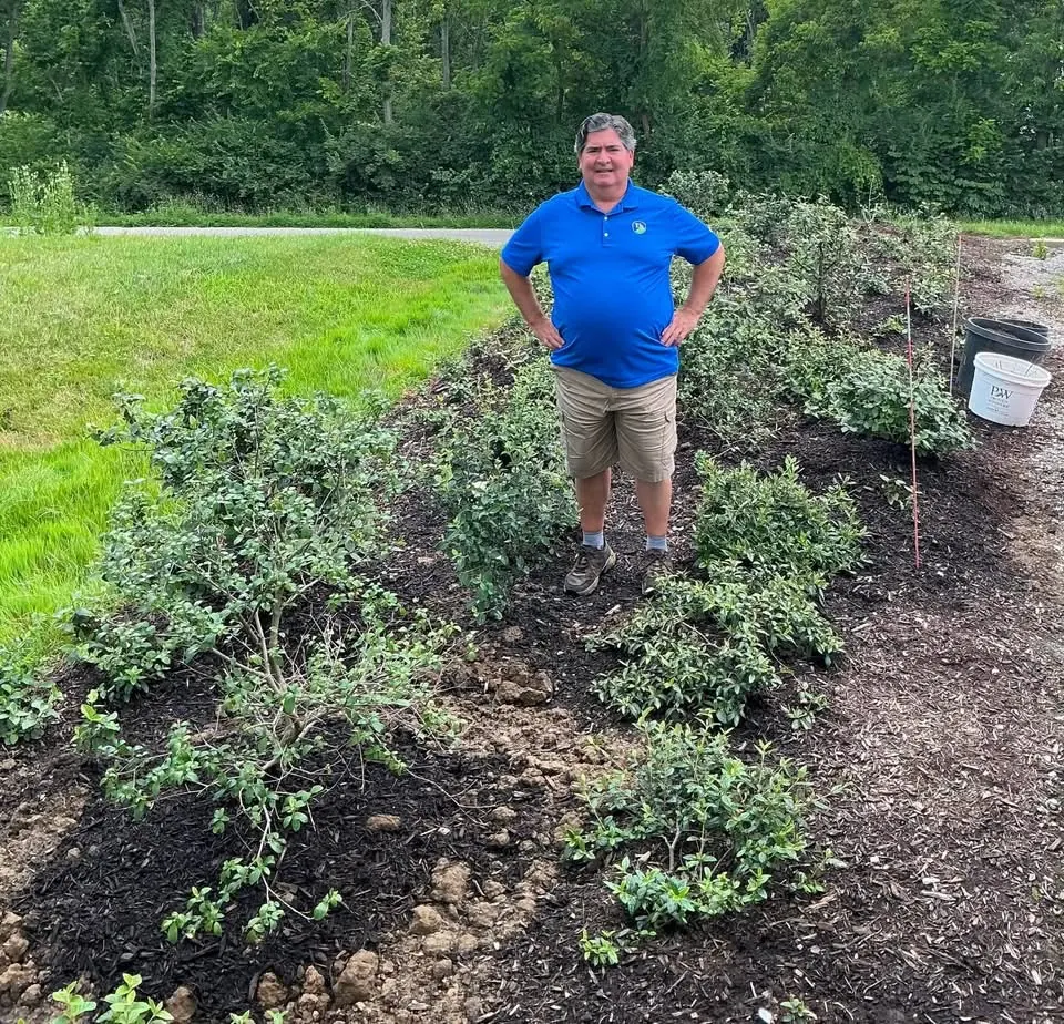 Registered Landscape Architect Tom standing among newly installed shrub beds