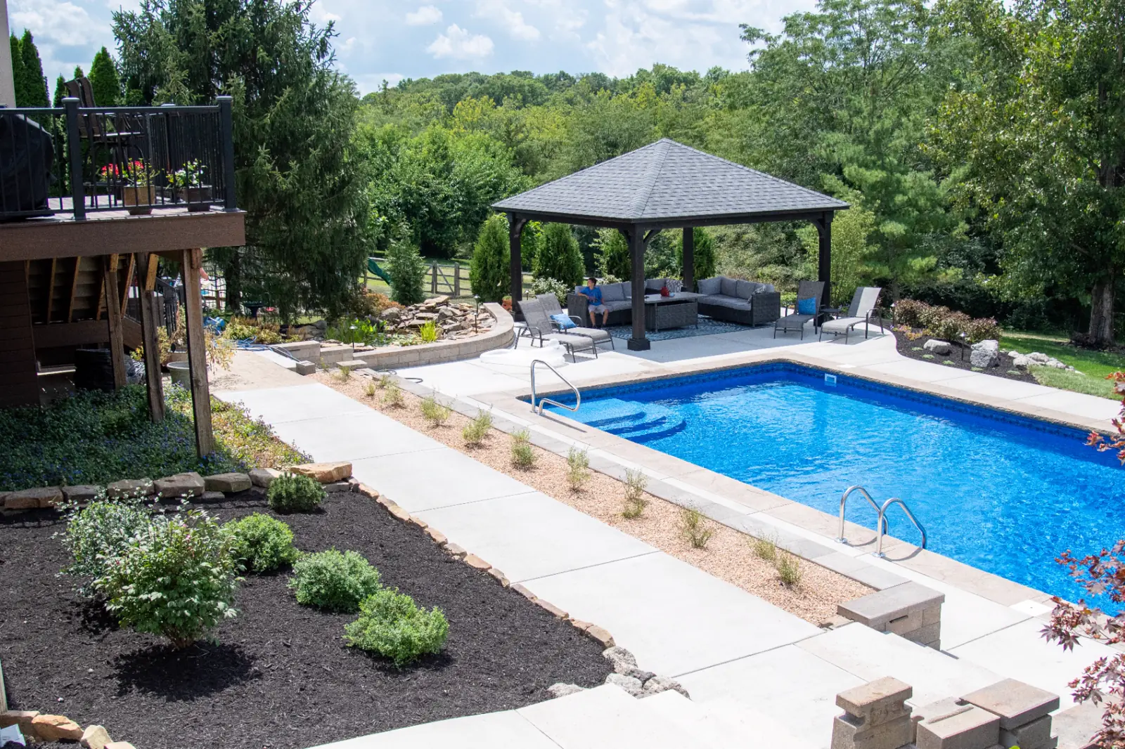 Complete backyard retreat with a swimming pool, timber pavilion, waterfall pond, terraces and upper deck