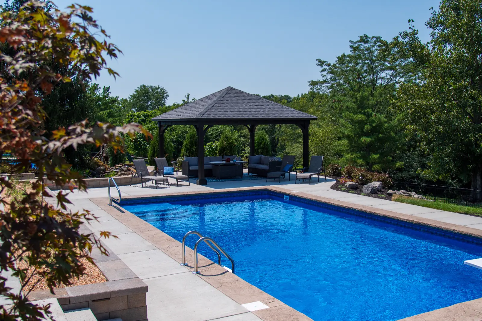 Woodland pool, stone coping and custom timber pavilion built by TJ's Landscaping in Greater Cincinnati