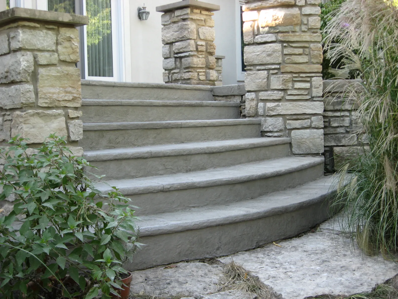 Curved bluestone steps between stone veneer columns