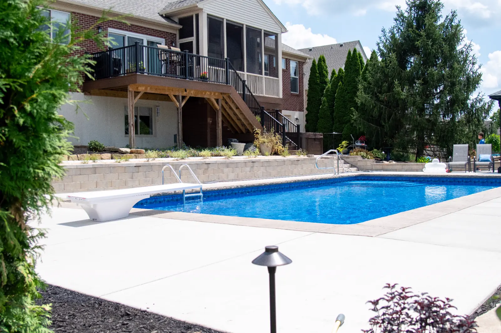 Upper deck, terraced walls, pool and pavilion unified in a complete backyard design