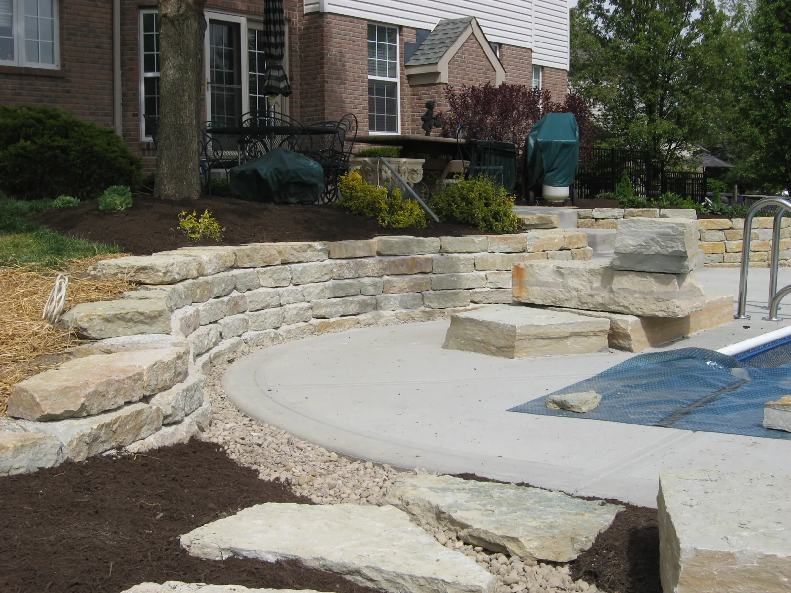 Limestone wall and slab steps around a pool deck