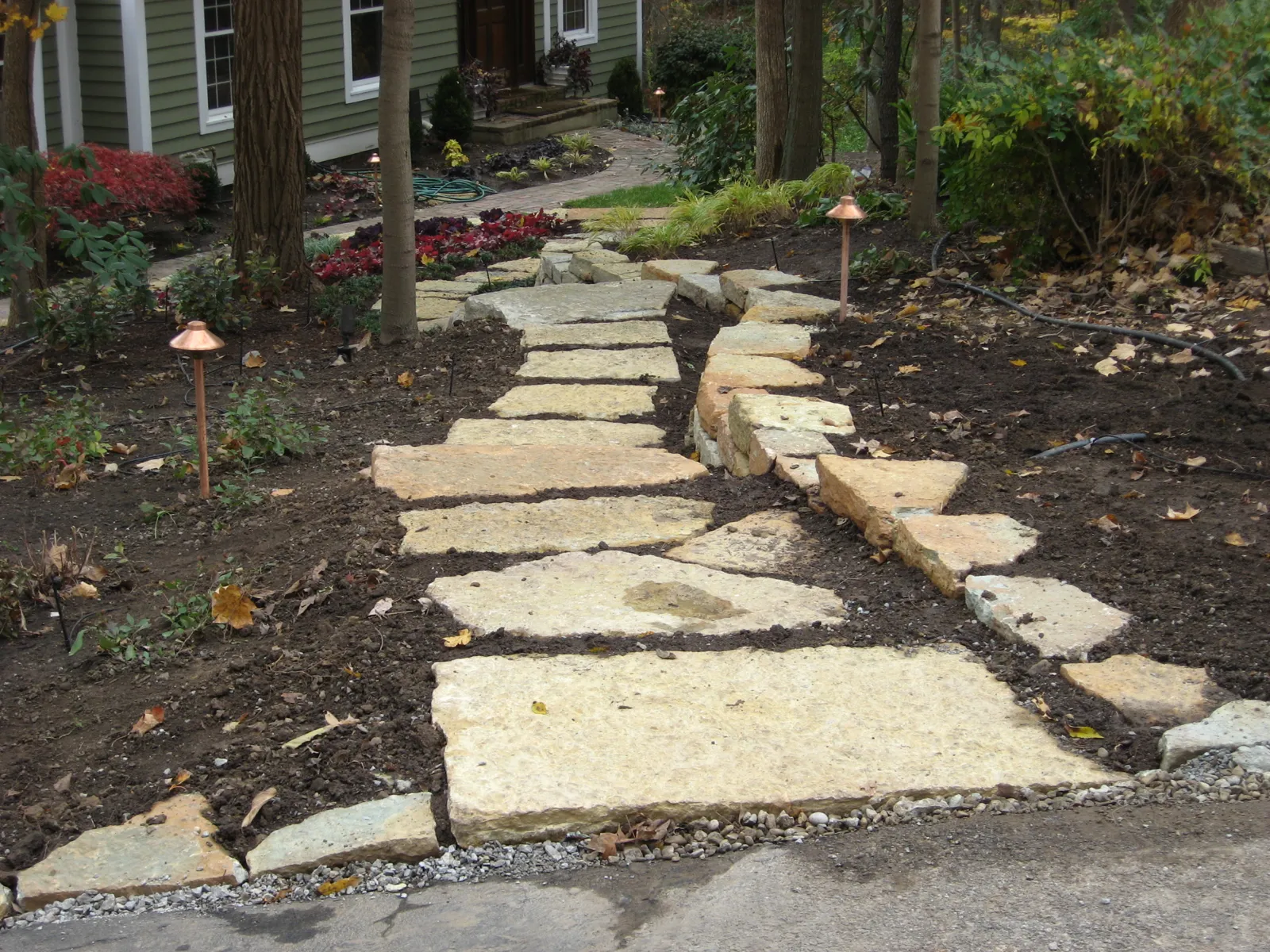 Large limestone stepping stones leading to the front entry