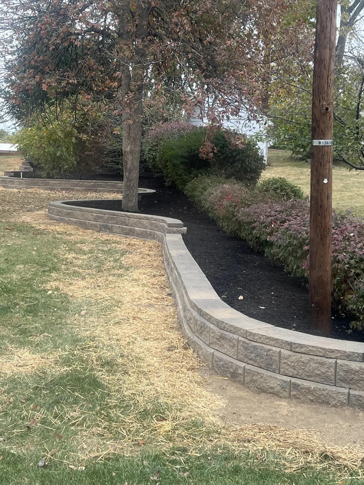 Curved block wall edging a planting bed