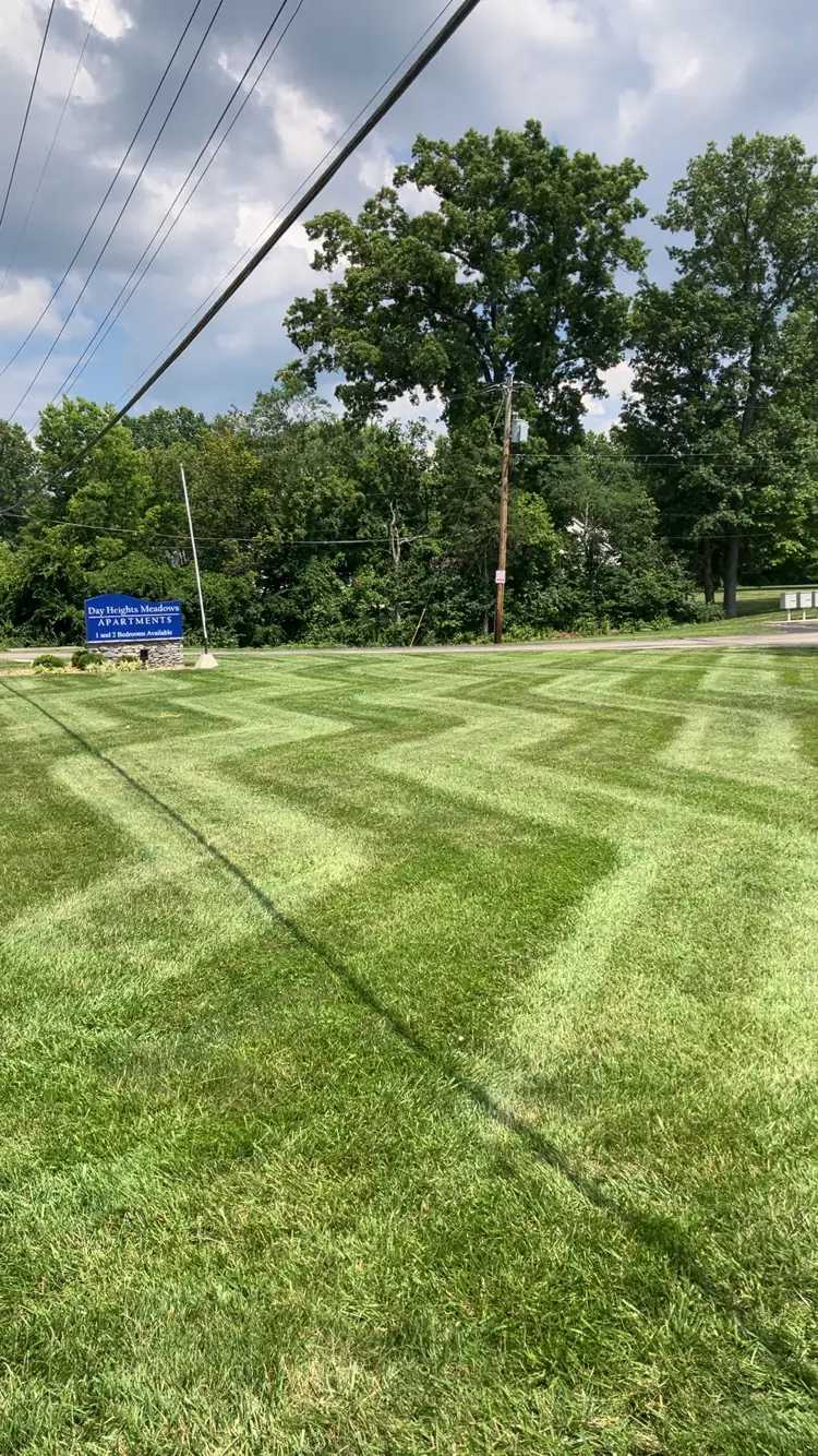 Maintained lawn and planting borders around a fenced backyard pool in Clermont County, Ohio