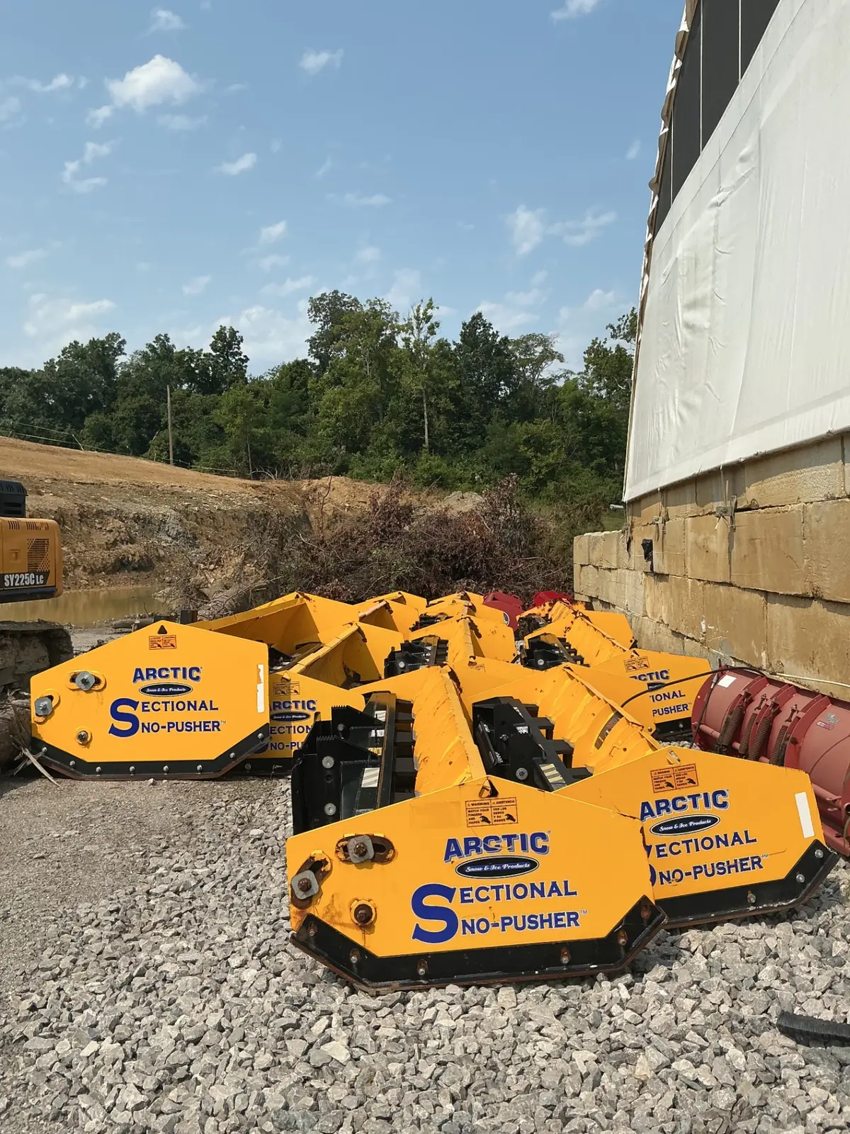 TJ's plow trucks fitted with snow blades, staged and ready for a storm