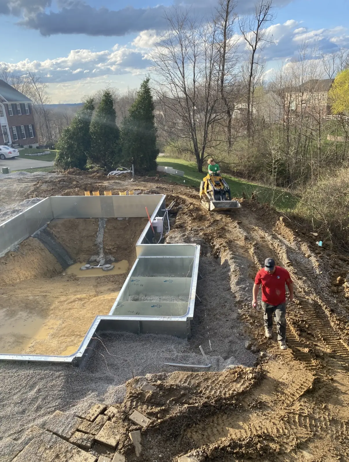 TJs Landscaping owner and son working during a pool excavation