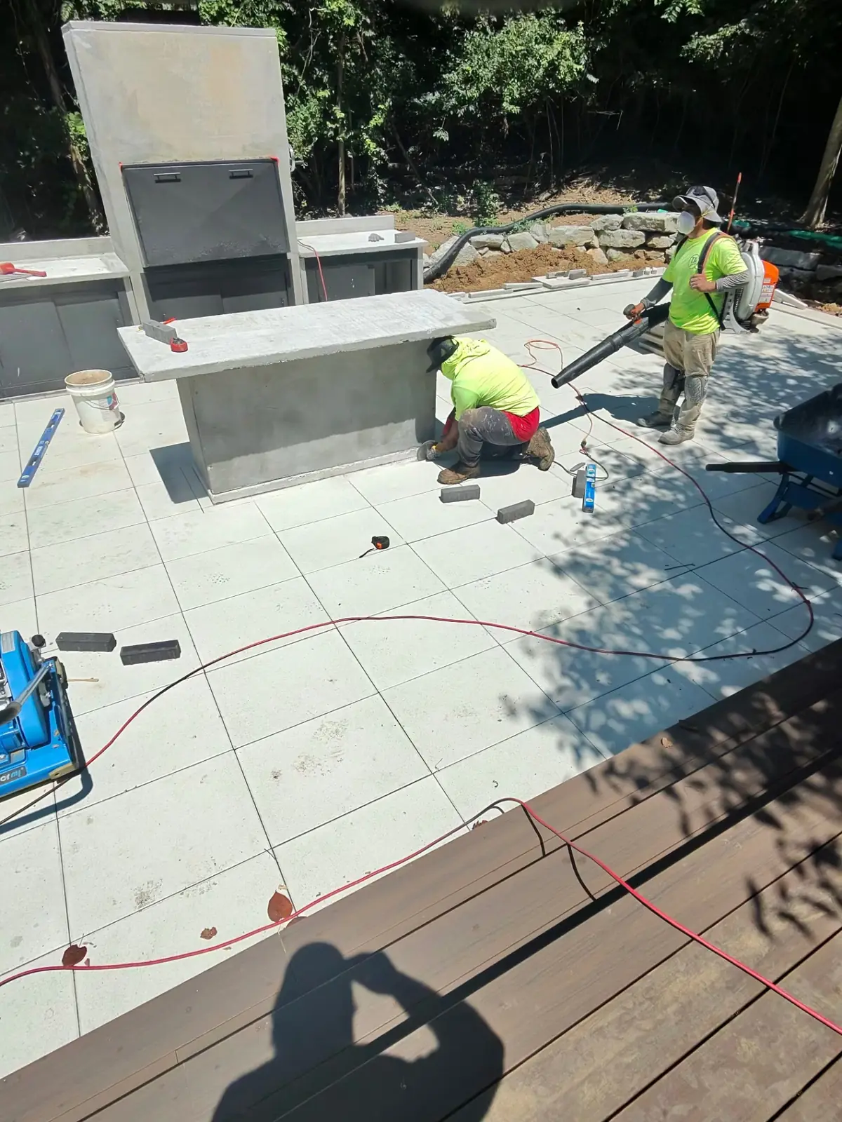 TJs craftsperson cutting stone for a custom outdoor kitchen